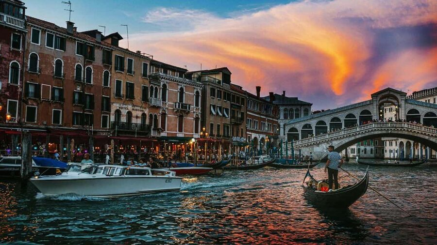 Venice: Shared Gondola Ride at Sunset - Boarding a gondola shared with up to four people